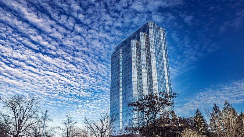 Modern skyscraper against blue sky