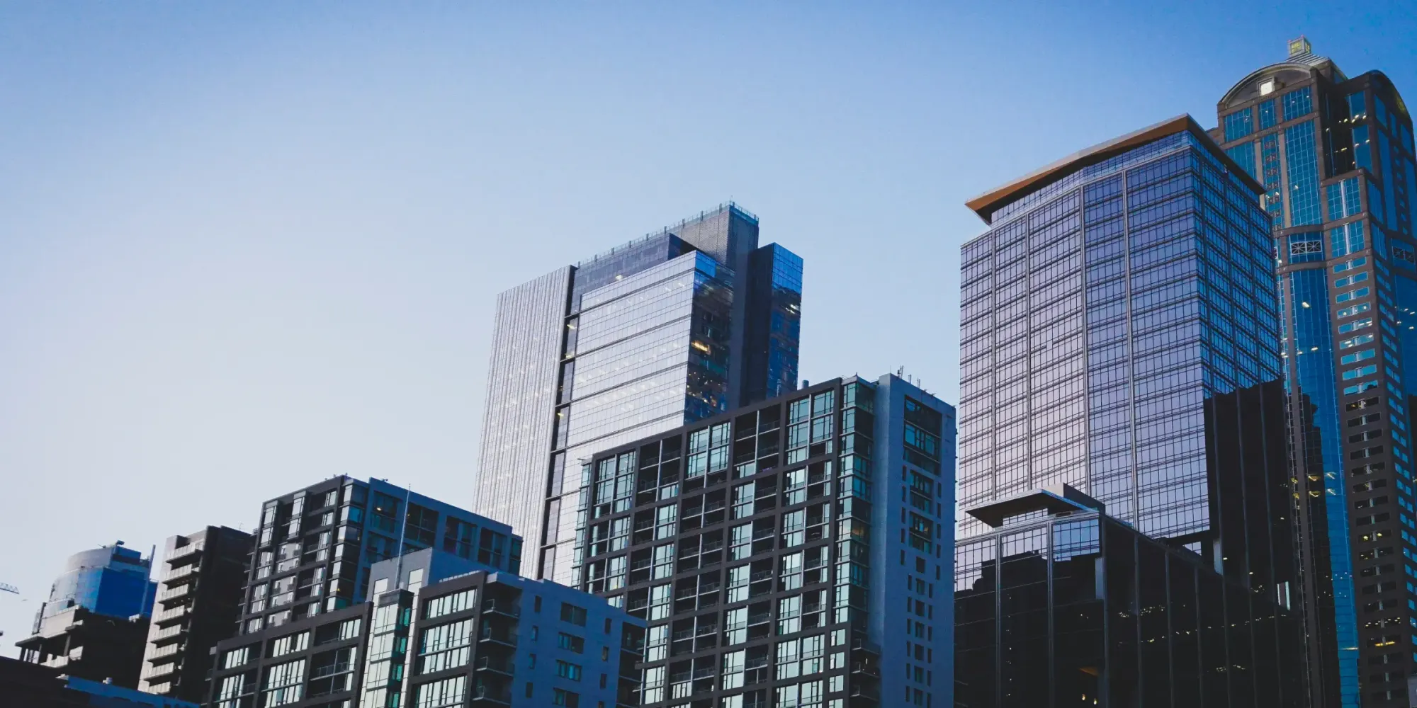 Generic modern skyscraper — representing the global shift toward digital real estate ownership.