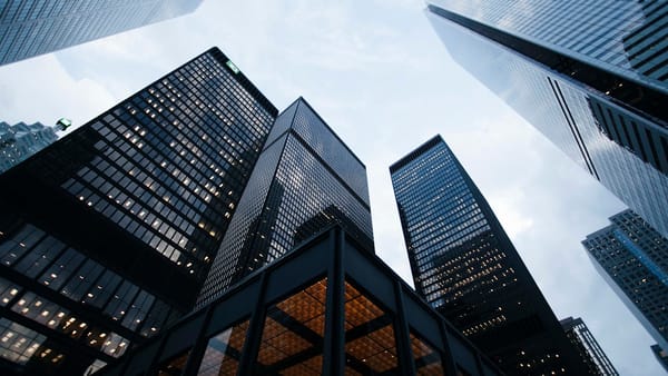 Modern financial district skyline representing the growing ecosystem of real estate tokenization companies in 2026